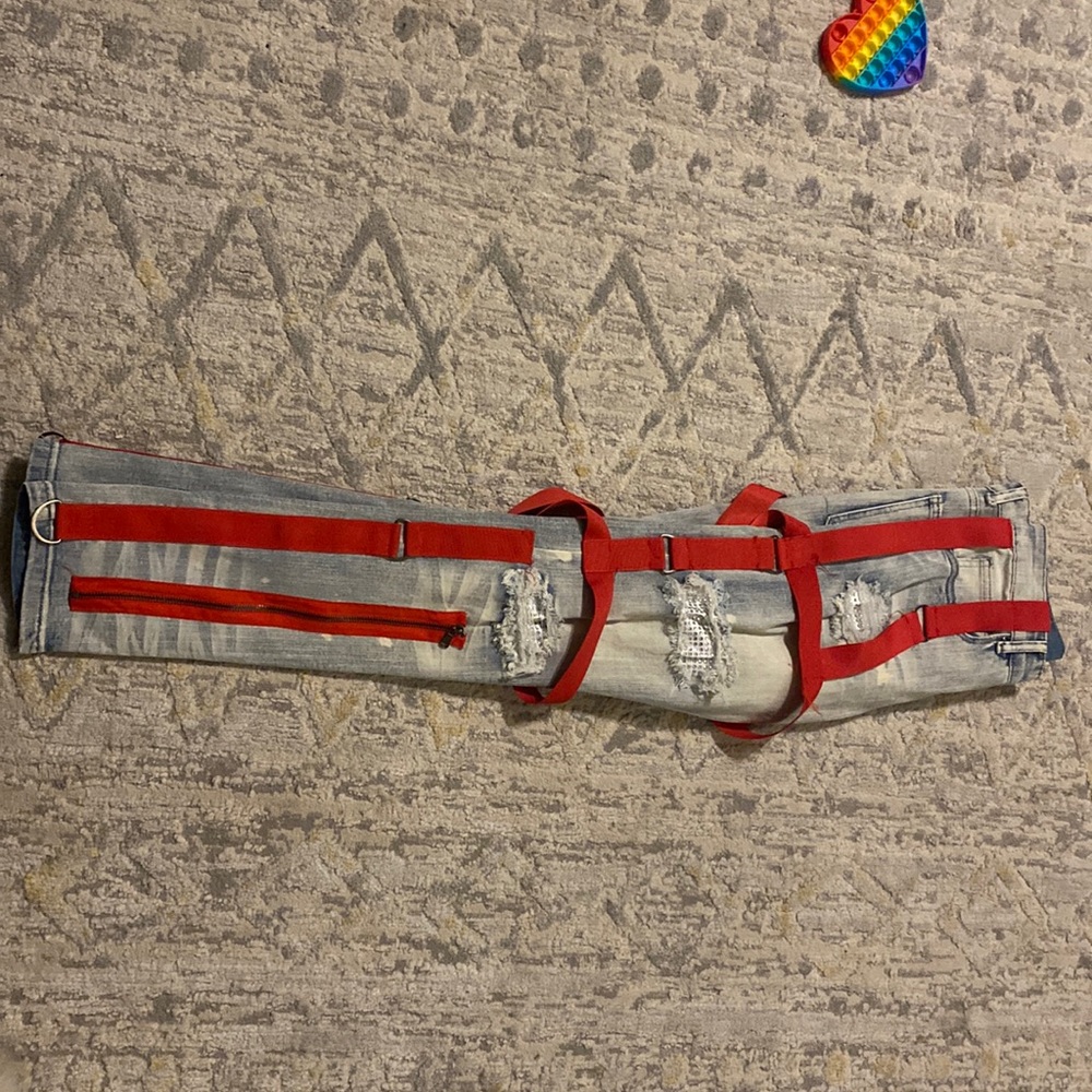 Blue jean red belt loop jeans with zippers.